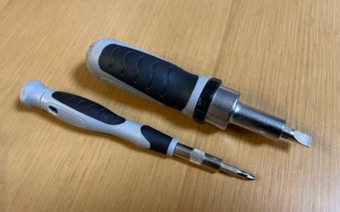 Two screwdrivers on wooden surface