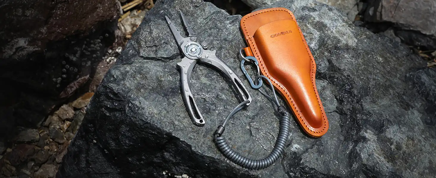 Gomexus Titanium Fishing Pliers 7.5'' for Saltwater Jigging Never Rust Split Ring Design 4 Pliers with leather sheath on rock.